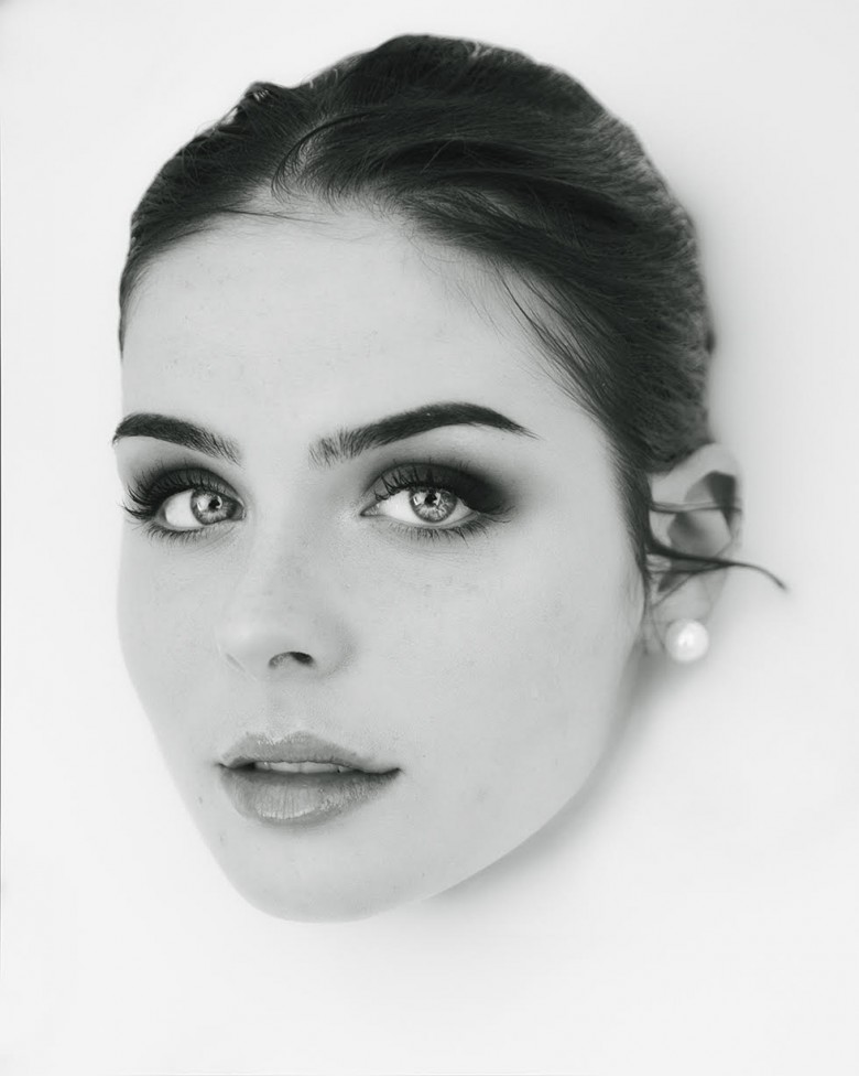 Black and white head shot of a young woman in a milk bath by NB photographer, Jason Bowie.