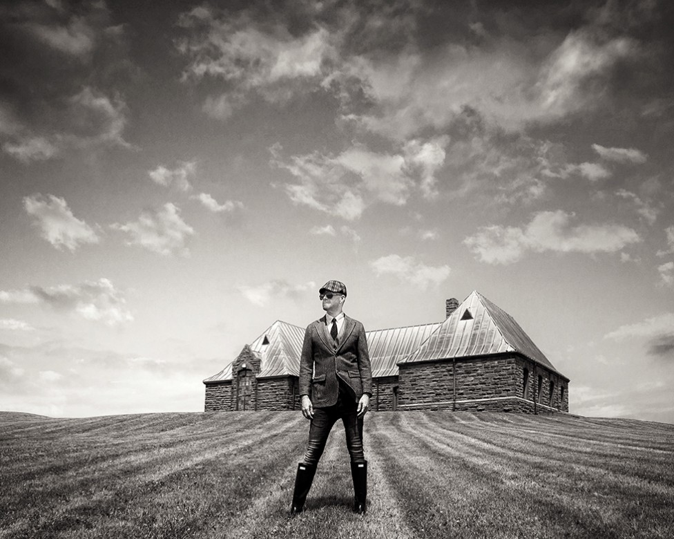 A vintage style photo of a man in period costume at Fort Beausejour