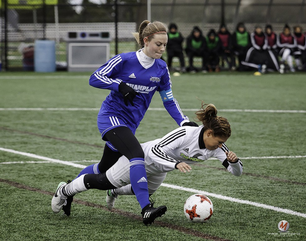 A well timed women's soccer photo by PE sports photographer, Mike Bernard