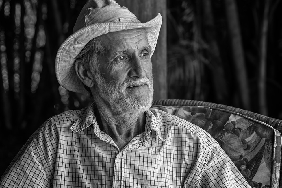 Black and white portrait of a man in a hat, by Berni Wood