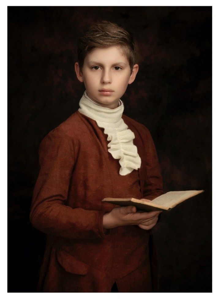 A portrait of a young man holding a book, by Jamie Bard