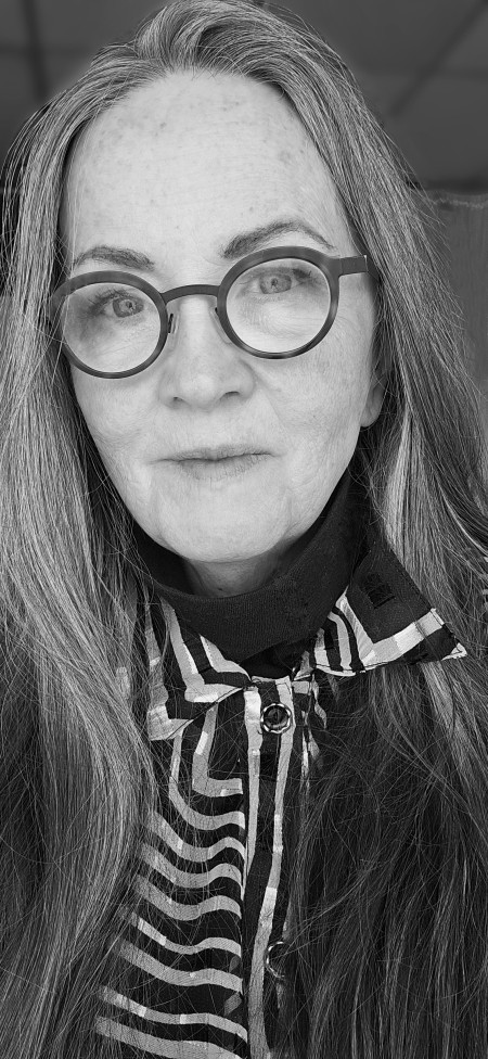 A black and white headshot of photographer Philomena Hughes